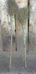 two brooms on a wall