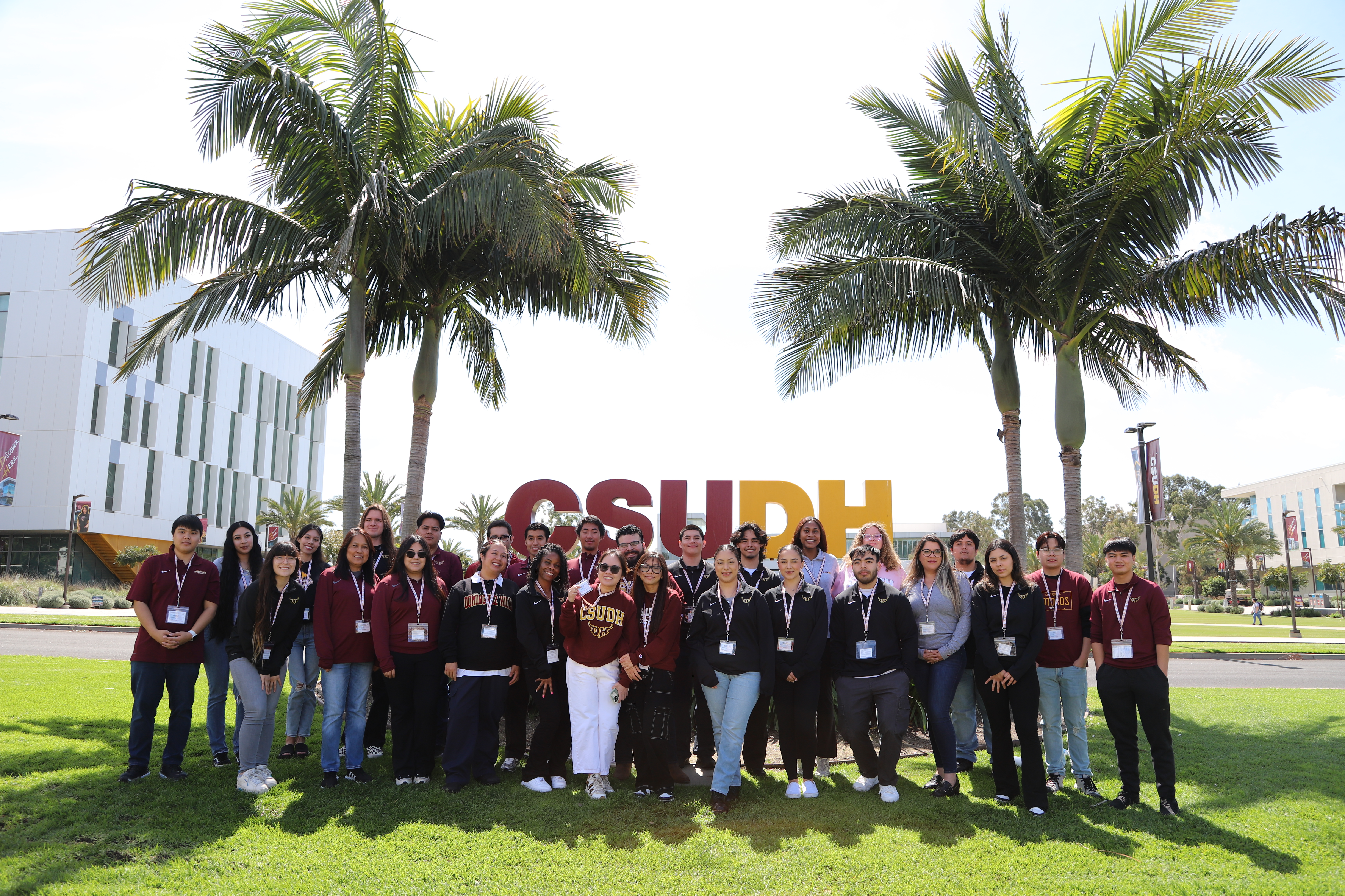 group of volunteers standing next to the CSUDH sign