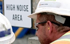 Construction worker wearing protective ear equipment